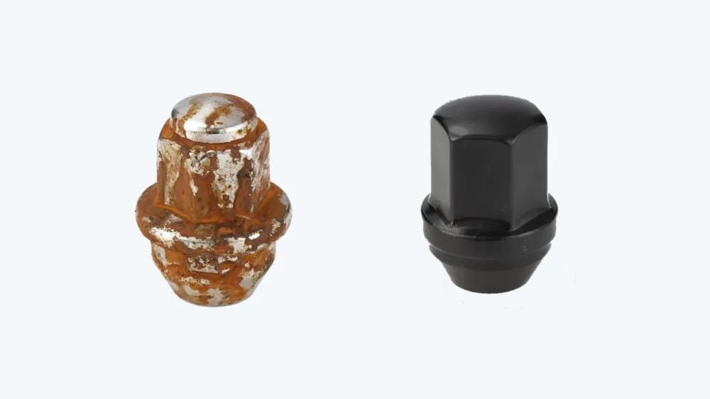 Rusted chrome lug nut next to a black-coated lug nut after salt-spray testing